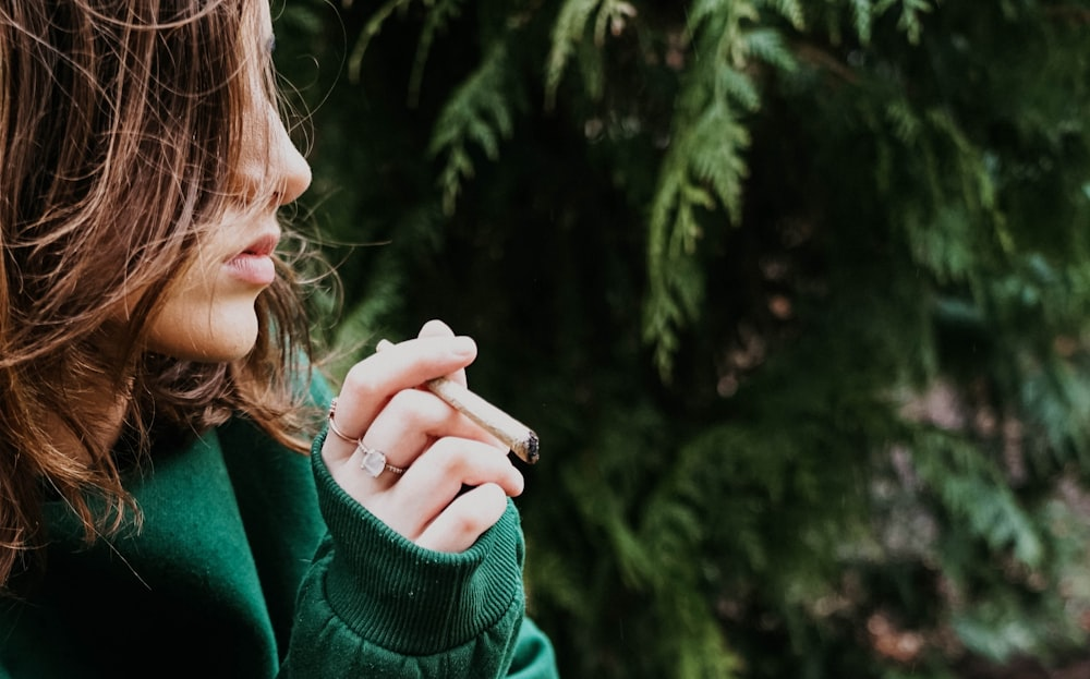 A person smoking a THCA flower pre-roll