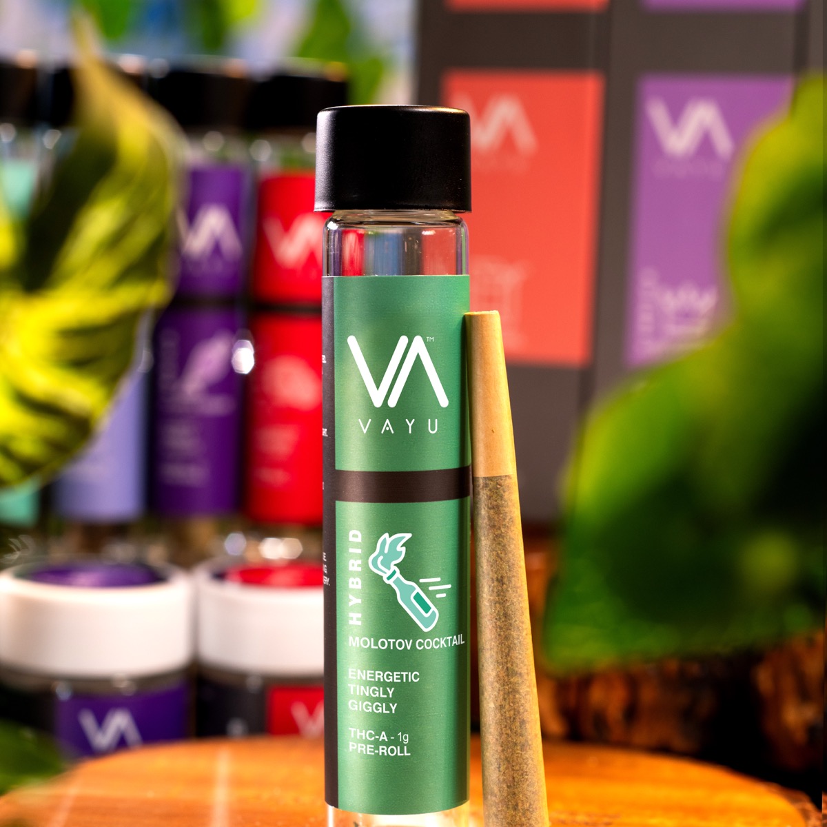Green Vayu vape bottle in focus with black cap, label reads 'Hybrid Molotov Cocktail' and 'Energetic' in a colorful shop display.